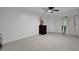 Spacious living room with tile flooring, modern ceiling fan, and a serene ambiance with natural light at 874 Quarters Ct, Port Orange, FL 32129