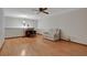 A well-lit living room features wood flooring, a ceiling fan, and a cozy seating area at 874 Quarters Ct, Port Orange, FL 32129