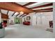 Spacious living room featuring beamed ceilings, tiled floors, fireplace, and chandelier lighting at 874 Quarters Ct, Port Orange, FL 32129