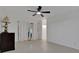 Spacious living room with tile flooring, modern ceiling fan and natural light from the window at 874 Quarters Ct, Port Orange, FL 32129