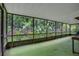 Enclosed sunroom provides ample natural light and views of the lush greenery outside at 874 Quarters Ct, Port Orange, FL 32129