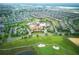 Stunning aerial view of the Oasis Club House and surrounding community, showcasing the pool and golf course at 8961 Cabot Cliffs Dr, Davenport, FL 33896