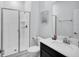 Bright bathroom with a glass-enclosed shower, modern vanity, and neutral decor at 8961 Cabot Cliffs Dr, Davenport, FL 33896