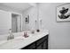 Modern bathroom featuring double sinks, a large mirror and sleek fixtures at 8961 Cabot Cliffs Dr, Davenport, FL 33896