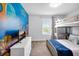 Bright bedroom featuring a bunk bed, a tv, and a large ocean-themed wall graphic at 8961 Cabot Cliffs Dr, Davenport, FL 33896