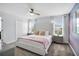 Bright bedroom with a queen bed, modern fan, and a closet at 8961 Cabot Cliffs Dr, Davenport, FL 33896