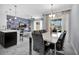 Elegant dining area featuring modern lighting and seamless open-concept layout to the living room at 8961 Cabot Cliffs Dr, Davenport, FL 33896