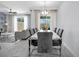 Elegant dining area adjacent to living room featuring modern lighting and a seamless open-concept layout at 8961 Cabot Cliffs Dr, Davenport, FL 33896