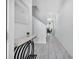Bright hallway with marble tile flooring leading to a dining area with decor at 8961 Cabot Cliffs Dr, Davenport, FL 33896