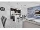 Open-concept kitchen with dark cabinets, stainless steel appliances, and a breakfast bar at 8961 Cabot Cliffs Dr, Davenport, FL 33896