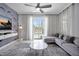Cozy living room featuring a stylish accent wall, plush seating, and sliding glass doors to the pool area at 8961 Cabot Cliffs Dr, Davenport, FL 33896