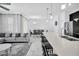 Open-concept living space with modern kitchen, dining area, and comfortable seating on tile flooring at 8961 Cabot Cliffs Dr, Davenport, FL 33896