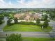Aerial view of the Oasis Club House surrounded by manicured landscaping, pools, and neighborhood streets at 8961 Cabot Cliffs Dr, Davenport, FL 33896