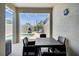 Covered patio with a dining table overlooking the screened-in pool area at 8961 Cabot Cliffs Dr, Davenport, FL 33896