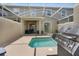 Outdoor patio with a private pool, covered seating, and a built-in grill, perfect for entertaining at 8961 Cabot Cliffs Dr, Davenport, FL 33896