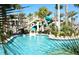 Resort-style pool with slides, lush landscaping, and clear blue water for Gathering fun at 8961 Cabot Cliffs Dr, Davenport, FL 33896