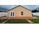Back exterior with French doors leading to a brick patio and a view of the grassy backyard at 1001 Golfside Ct, Kissimmee, FL 34741