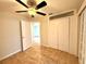 Bedroom with tile floors, ceiling fan, and a pair of white double closets at 1001 Golfside Ct, Kissimmee, FL 34741