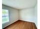 Bedroom with neutral walls features wood flooring and a large window at 1001 Golfside Ct, Kissimmee, FL 34741
