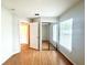 Open bedroom with wood floors has natural light and a mirrored closet at 1001 Golfside Ct, Kissimmee, FL 34741