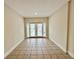 Empty bedroom with tile floor and sliding glass door leading to the backyard at 1001 Golfside Ct, Kissimmee, FL 34741