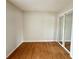 Bedroom with wood floors features a mirrored closet and base molding at 1001 Golfside Ct, Kissimmee, FL 34741