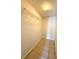 Walk-in closet features tile floor and wire shelving unit for optimal storage at 1001 Golfside Ct, Kissimmee, FL 34741