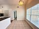 Open dining area with tile flooring and large window offers views to the backyard at 1001 Golfside Ct, Kissimmee, FL 34741