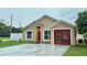 Inviting single-story home featuring a modern exterior and attached garage at 1001 Golfside Ct, Kissimmee, FL 34741