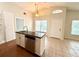 Eat-in kitchen features a stainless steel dishwasher, light-toned cabinets, and wooden floors at 1001 Golfside Ct, Kissimmee, FL 34741