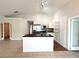 Open layout showcasing the kitchen with modern appliances and adjoining living area at 1001 Golfside Ct, Kissimmee, FL 34741