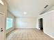 Neutral living area highlighting tile flooring and a view into the doorway at 1001 Golfside Ct, Kissimmee, FL 34741