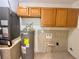 Utility room features a water heater, cabinets, and washer/dryer hookups at 1001 Golfside Ct, Kissimmee, FL 34741