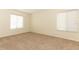 Bright bedroom with neutral carpet, two windows with blinds, and a spacious feel at 1221 S Pine Ridge Cir # A2, Sanford, FL 32773