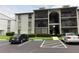 Exterior view of multi-story condo building with parking at 1221 S Pine Ridge Cir # A2, Sanford, FL 32773