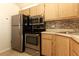 Kitchen features stainless steel appliances and light wood cabinets at 1221 S Pine Ridge Cir # A2, Sanford, FL 32773