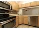 Kitchen showcases stainless steel appliances, tile backsplash, and ample counter space at 1221 S Pine Ridge Cir # A2, Sanford, FL 32773