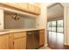 Kitchen with stainless steel dishwasher and wooden cabinets at 1221 S Pine Ridge Cir # A2, Sanford, FL 32773