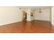 The spacious living room features laminate floors, a view into the kitchen and a chandelier at 1221 S Pine Ridge Cir # A2, Sanford, FL 32773