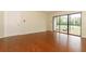 The living room features laminate floors and a sliding glass door with access to the screened-in porch at 1221 S Pine Ridge Cir # A2, Sanford, FL 32773