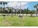 Community picnic area with a table, grill, and grassy space, ideal for outdoor dining and recreation at 1221 S Pine Ridge Cir # A2, Sanford, FL 32773