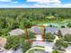 Aerial view of house in landscaped neighborhood near lake, with a large backyard at 1375 Brayford Point, Deland, FL 32724