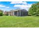 Well-maintained backyard showcasing a screened lanai and lush lawn at 1375 Brayford Point, Deland, FL 32724