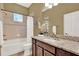 Bathroom with a tub and shower combination, a granite vanity, and a decorative mirror at 1375 Brayford Point, Deland, FL 32724