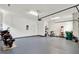 Open garage space featuring an painted floor, storage, and access to interior of the house at 1375 Brayford Point, Deland, FL 32724