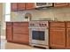 Close up on a kitchen featuring a stainless steel oven and range against the backsplash at 1375 Brayford Point, Deland, FL 32724