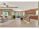 Open-concept kitchen featuring an island with seating, stainless appliances, and adjoined living and dining spaces at 1375 Brayford Point, Deland, FL 32724