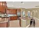 Spacious kitchen features an island, stainless steel appliances, and custom wood cabinetry at 1375 Brayford Point, Deland, FL 32724