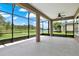 Spacious screened lanai with peaceful views, ceiling fan, and outdoor living space at 1375 Brayford Point, Deland, FL 32724