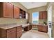 Functional laundry room with generous counter space and built-in cabinets for efficient organization at 1375 Brayford Point, Deland, FL 32724